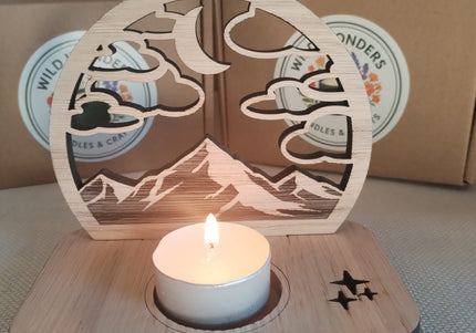 Wooden candle holder with a lit tealight candle on a textured surface, with 'Wild Wonders' branding in the background.