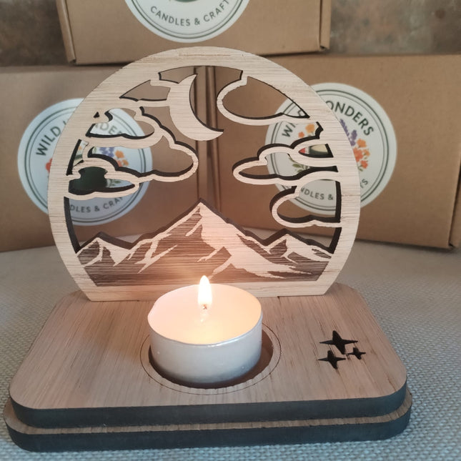 Wooden candle holder with a lit tealight candle on a textured surface, with 'Wild Wonders' branding in the background.