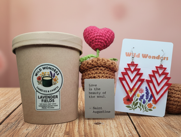 Cup of lavender ice cream with a card and small crocheted plants on a wooden surface.