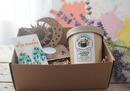 Gift set with earrings, candle, and decorative items in a box