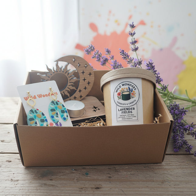 Gift set with earrings, candle, and decorative items in a box